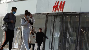 People walk past an H&M store in a shopping area in Beijing, China, on March 28, 2021. (Reuters)