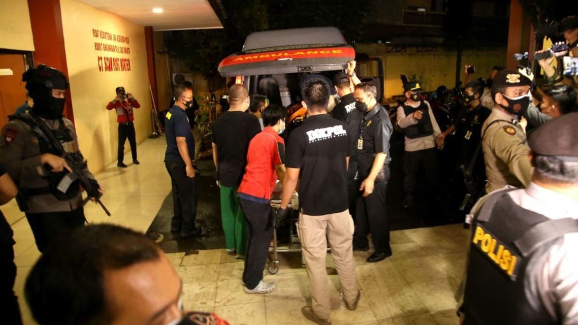 Police officers move the body of a person at the Indonesia National Police Headquarters in Jakarta on March 31, 2021, after authorities shot the person who entered the compound which local media described as an alleged terror attack. (AFP)