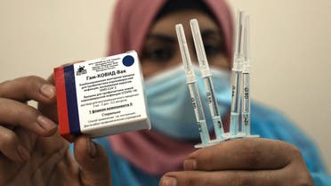 A Palestinian health worker shows a box of the Russian Sputnik V COVID-19 vaccine in Gaza City on March 22, 2021. (AFP)