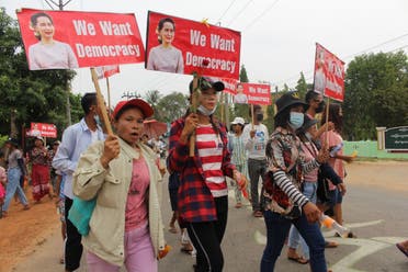 This handout photo taken and released by Dawei Watch on March 30, 2021 shows protesters holding signs with portraits of detained Myanmar civilian leader Aung San Suu Kyi during a demonstration against the military coup in Launglon township in Dawei.