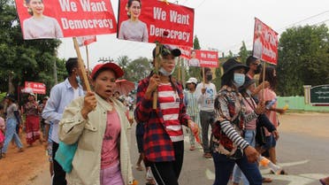 This handout photo taken and released by Dawei Watch on March 30, 2021 shows protesters holding signs with portraits of detained Myanmar civilian leader Aung San Suu Kyi during a demonstration against the military coup in Launglon township in Dawei.