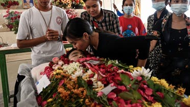 A relative of Khine Zar Twal, who died on March 28 during a protest amid a crackdown by security forces on demonstrations against the military coup, kisses her forehead during her funeral in Yangon on March 30, 2021. (File photo: AFP)