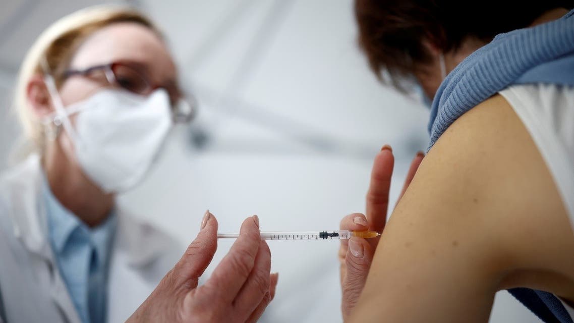 A nurse administers the Oxford-AstraZeneca COVID-19 vaccine to a member of the medical staff at a coronavirus vaccination center in La Baule, France. (Reuters)