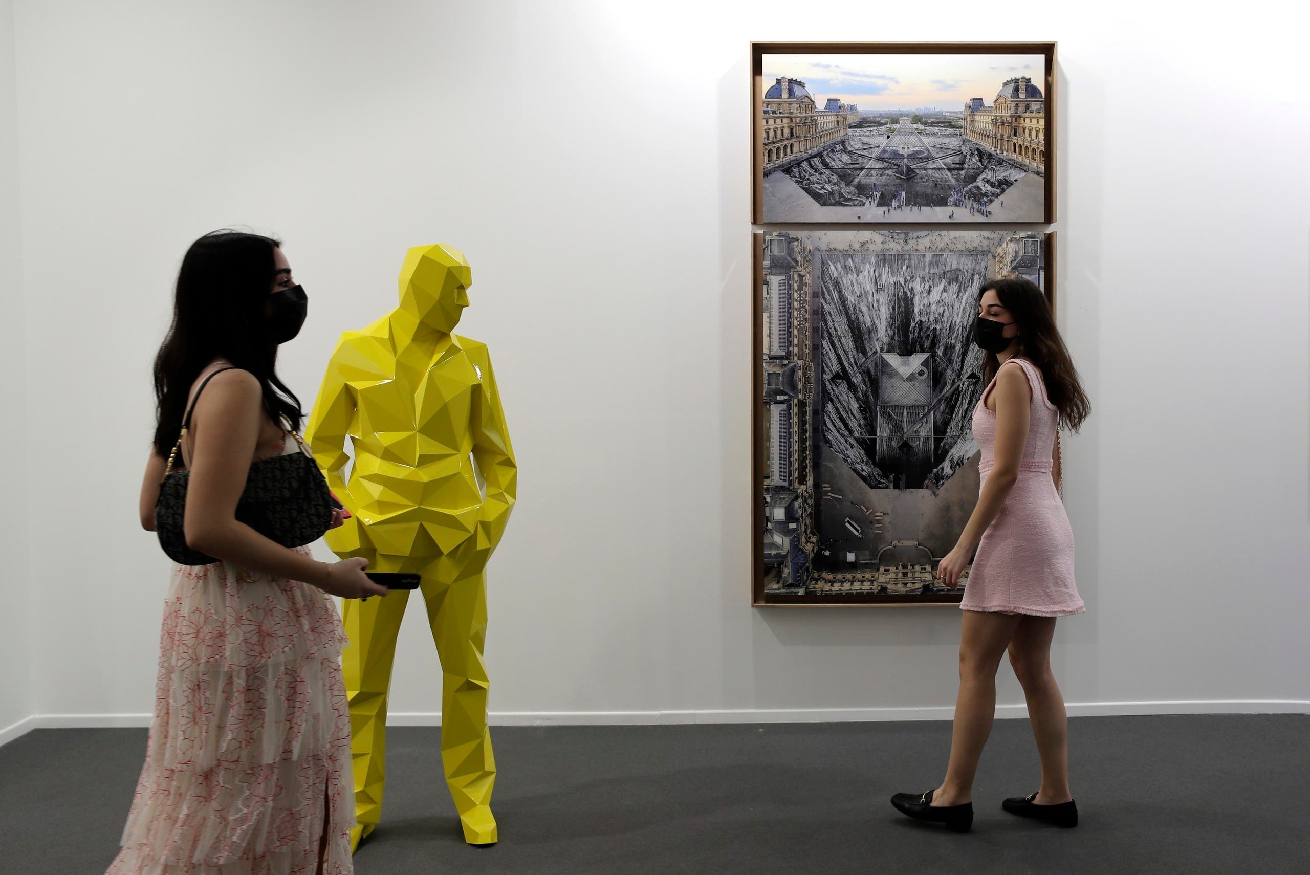 People visit Perrotin gallery of the 14th edition of Art Dubai at Dubai International Financial Centre, DIFC, which features 50 galleries from 31 countries with a focus on modern and contemporary art, in Dubai, United Arab Emirates, Tuesday, March 30, 2021. (File photo: AP))