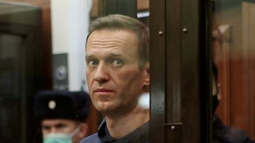 A still image taken from video footage shows Russian opposition leader Alexei Navalny, who is accused of flouting the terms of a suspended sentence for embezzlement, inside a defendant dock during the announcement of a court verdict in Moscow, Russia February 2, 2021. (Reuters)
