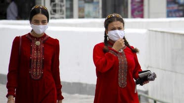 Turkmen women wearing face masks walk in Ashgabat on July 13, 2020. (AFP)