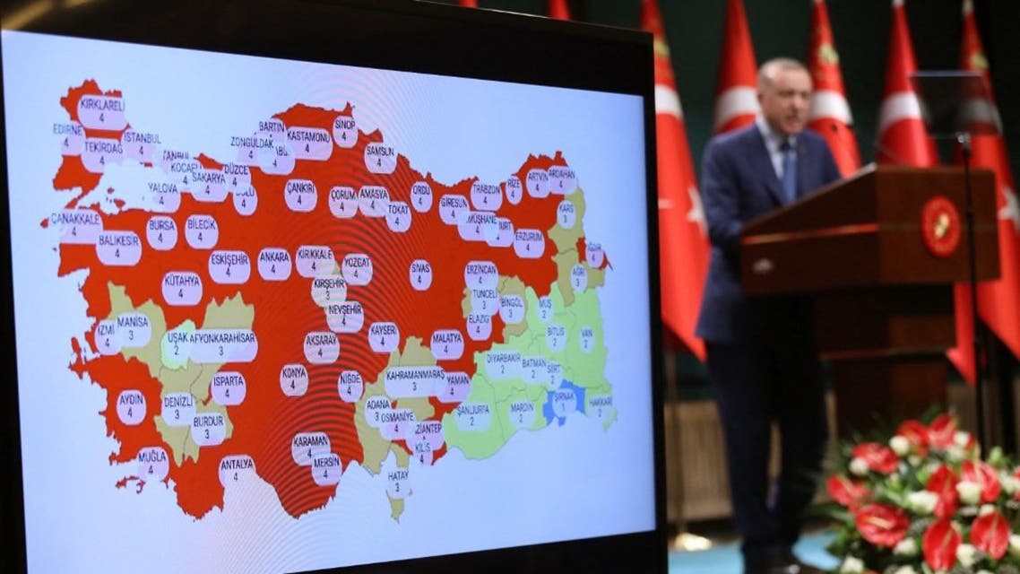 Turkish President Recep Tayyip Erdogan gives a press conference next to a map of Turkey with Covid-19 figures after the cabinet meeting at the presidential complex in Ankara, on March 29, 2021. (AFP)
