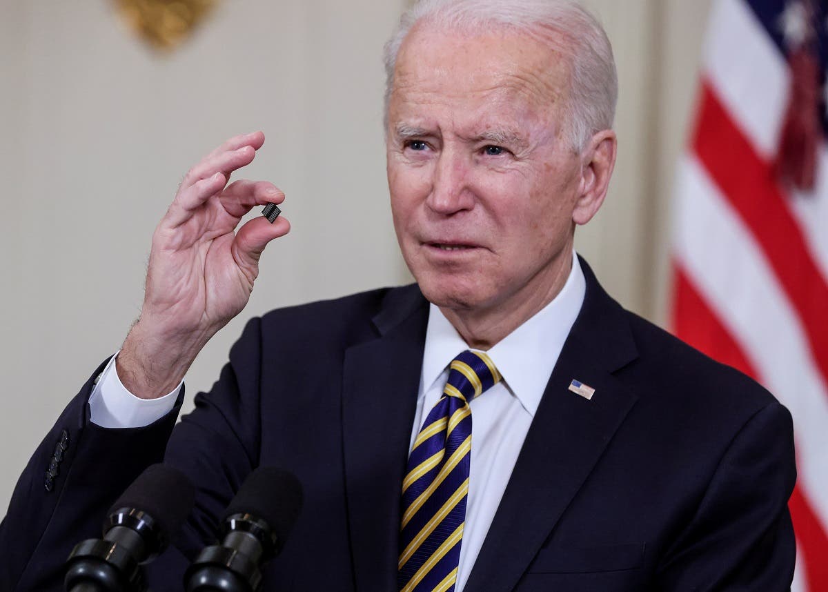 President Joe Biden holds a chip as he speaks prior to signing an executive order aimed at addressing a global semiconductor shortage, in the State Dining Room at the White House in Washington, US, on February 24, 2021. (Reuters)