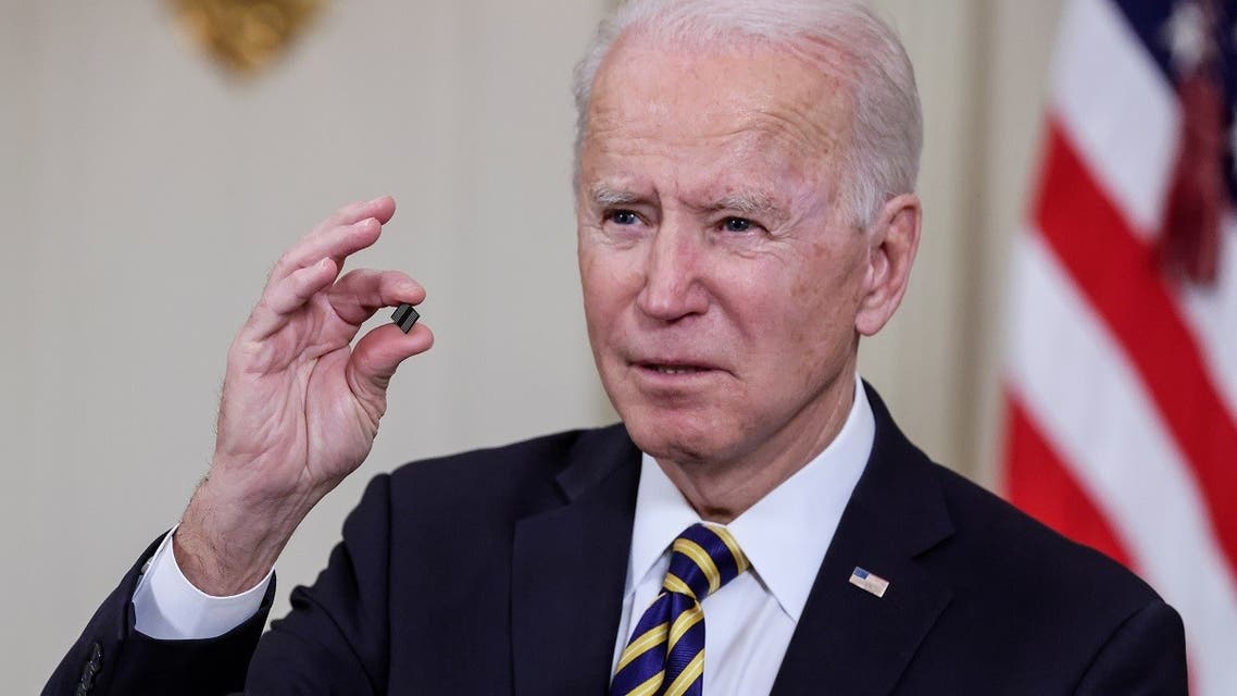 President Joe Biden holds a chip as he speaks prior to signing an executive order aimed at addressing a global semiconductor shortage, in the State Dining Room at the White House in Washington, US, on February 24, 2021. (Reuters)