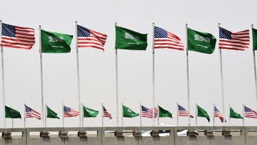 American and Saudi national flags are seen on a main road in Riyadh, on May 19, 2017. (AFP)