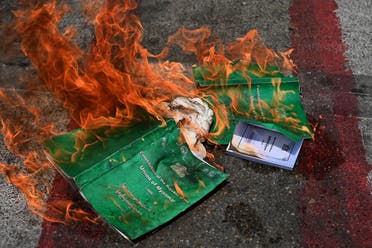 Copies of the 2008 constitution are burnt during a demonstration by protesters against the military coup in Yangon's South Okkalapa township on April 1, 2021. (File photo: AFP)