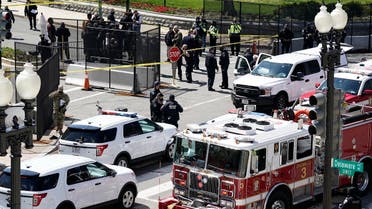 Police and fire officials stand near a car that crashed into a barrier on Capitol Hill April 2, 2021. (AP)