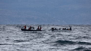 Migrants from sub-saharan African countries on a dinghy are towed by a rescue boat as they try to cross part of the Aegean Sea from Turkey to the island of Lesbos, Greece, February 29, 2020. (Reuters)