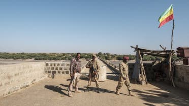 Two members of the Amhara Special Forces with a member of the Amhara militia (L) stand at the border crossing with Eritrea where an Imperial Ethiopian flag waves, in Humera, Ethiopia, on November 22, 2020. (File photo: AFP)