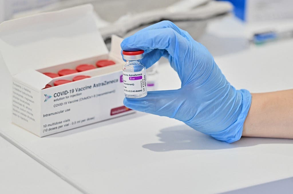 A medical worker holds a vial of the AstraZeneca vaccine against Covid-19 on March 24, 2021 at a vaccination hub outside Rome's Termini railway station. (AFP)