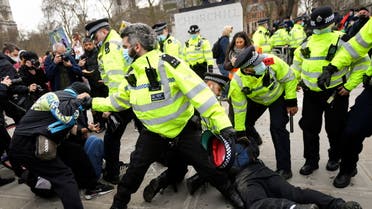 Police officers restrain demonstrators during a protest in London, Britain, April 3, 2021. (Reuters)
