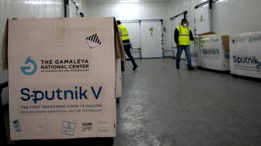 A worker handles boxes of the newly-received first batch of the Russian Sputnik V vaccine against the coronavirus, before stockpiling them in refrigerated units inside the storage facilities of the Libyan health ministry, in the capital Tripoli, on April 4, 2021.
