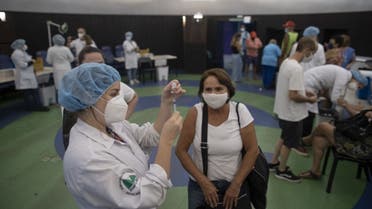 A nurse prepares a dose of China's Sinovac CoronaVac vaccine produced by Butantan, the largest vaccine producer in Brazil, at a vaccination centre against the novel coronavirus, COVID-19, mounted at the Public Planetarium in Rio de Janeiro, on March 31, 2021. (AFP)