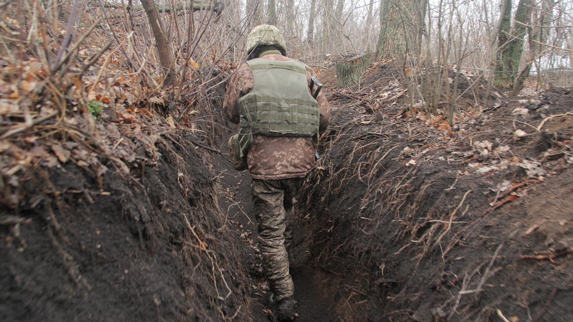A service member of the Ukrainian armed forces walks at fighting positions on the line of separation near the rebel-controlled city of Donetsk, Ukraine April 3, 2021. REUTERS/Serhiy Takhmazov