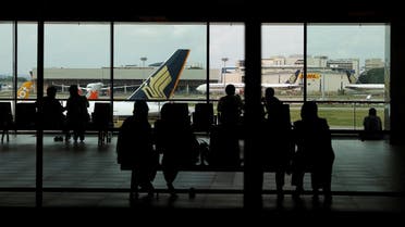 People look at a Singapore Airlines plane, amid the spread of the coronavirus, at a viewing gallery of the Changi Airport in Singapore. (File photo: Reuters)