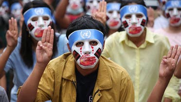 his handout from the Burma Associated Press (BAP) taken and received on April 4, 2021 shows protesters making the three-finger salute while wearing masks that express what they say is Chinese interference in the UN's handling of Myanmar affairs after the military coup in Yangon's Kamayut township. (File photo: AFP)