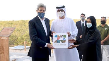 US Special Envoy for Climate John Kerry poses alongside UAE Special Envoy for Climate Change and Abu Dhabi National Oil Company CEO, Sultan Ahmed Al Jaber, at Jubail Mangrove Park, April 3, 2021. (Reuters)