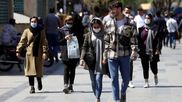 Iranian people wear protective face masks, as they walk amid the spread of the coronavirus disease (COVID-19), in Tehran, Iran March 30, 2021. (Reuters)
