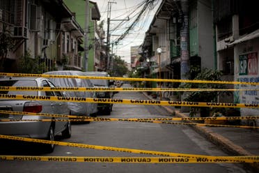 A view shows a makeshift barrier set up on a street of a village under lockdown amid rising coronavirus disease (COVID-19) infections, in Manila, Philippines, March 12, 2021. (Reuters)