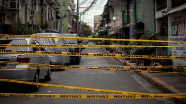 A view shows a makeshift barrier set up on a street of a village under lockdown amid rising coronavirus disease (COVID-19) infections, in Manila, Philippines, March 12, 2021. (Reuters)