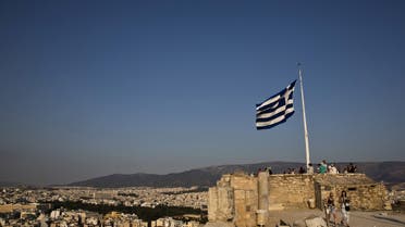 A Greek flag flutters in the wind as tourists visit the archaeological site of the Acropolis hill in Athens, Greece. (File photo: Reuters)