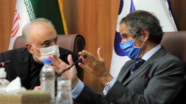 A handout picture provided by Iran's Atomic Energy Organisation shows the head of the country's atomic agency Ali Akbar Salehi (L) and Director General of the International Atomic Energy Agency (IAEA) Rafael Mariano Grossi holding a joint press conference in Tehran on August 25 2020. (AFP)