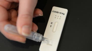 A pharmacist shows a COVID-19 saliva self-test kit in a drugstore in Brussels amid the coronavirus disease (COVID-19) outbreak in Belgium, April 6, 2021. (File photo: Reuters)