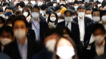 Commuters wearing protective face masks, amid the coronavirus disease (COVID-19) pandemic, make their way in Tokyo, Japan, April 6, 2021. Picture taken with slow shutter speed. REUTERS/Kim Kyung-Hoon