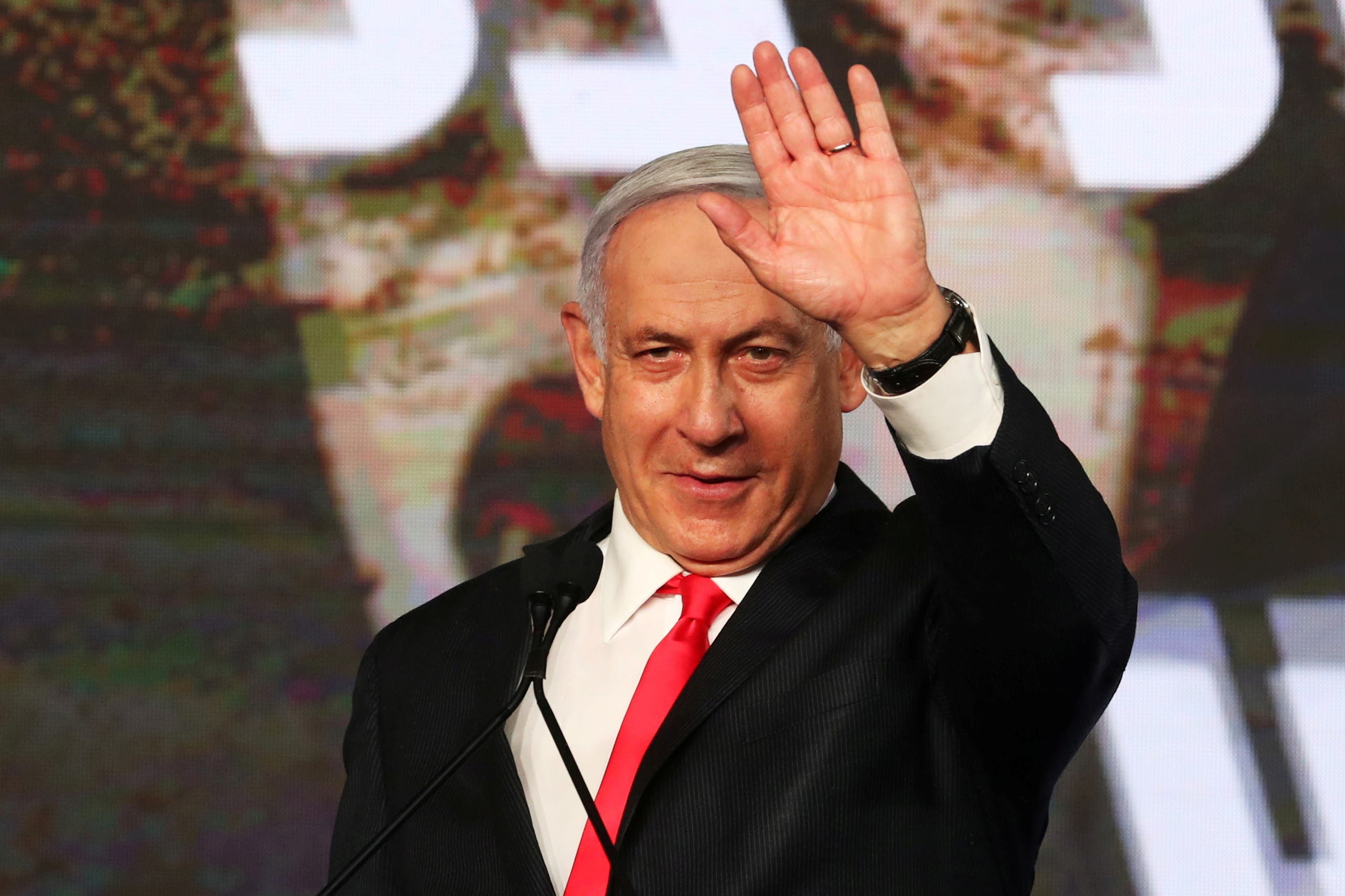 Israeli Prime Minister Benjamin Netanyahu gestures as he delivers a speech to supporters following the announcement of exit polls in Israel's general election at his Likud party headquarters in Jerusalem March 24, 2021. (Reuters)
