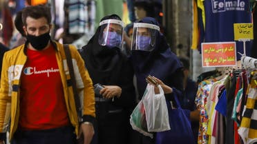 Iranian women wear protective face shields and masks as they walk in Tehran Bazaar in Tehran, Iran April 6, 2021. Majid Asgaripour/WANA (West Asia News Agency) via REUTERS ATTENTION EDITORS - THIS IMAGE HAS BEEN SUPPLIED BY A THIRD PARTY.