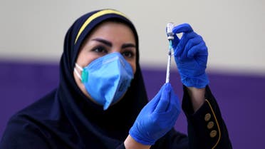 An Iranian health worker prepares an injection of the locally-made COVID-19 vaccine during the start of the second phase of trials in the capital Tehran on March 15, 2021.