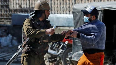 An Indian police officer detains a demonstrator during a protest after Friday prayers in Srinagar on March 5, 2021. (Reuters)