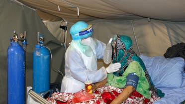 FILE PHOTO: A nurse attends to a woman at a coronavirus disease (COVID-19) quarantine center in Aden, Yemen March 27, 2021. Picture taken March 27, 2021. REUTERS/Fawaz Salman/File Photo