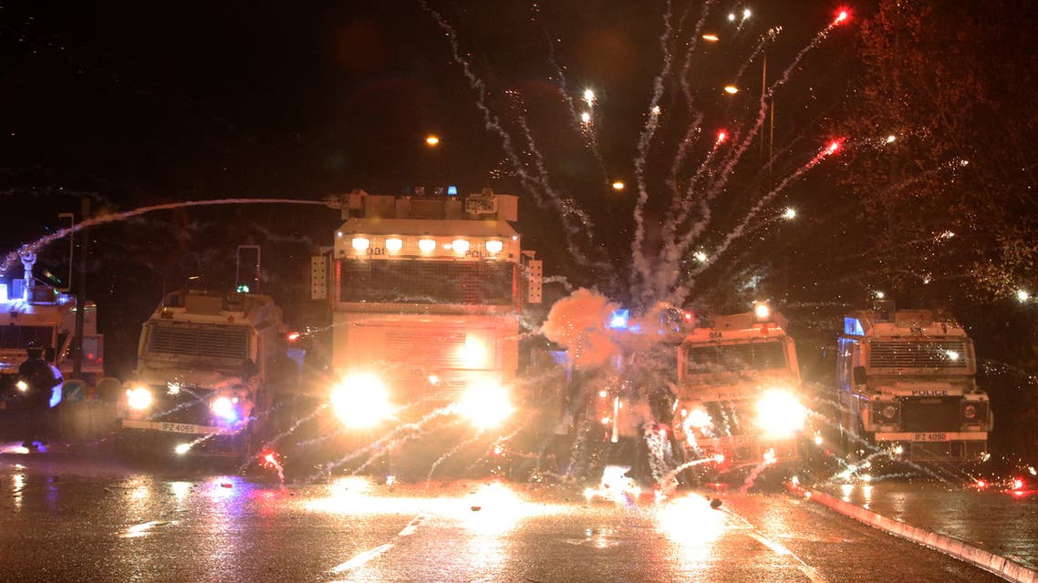 Fireworks explode at police vehicles after being fired at police officers with a water cannon during clashes with nationalist youths in the Springfield Road area of Belfast on April 8, 2021 as disorder continued in the Northern Ireland capital following days of mainly loyalist violence. Northern Ireland police faced a barrage of petrol bombs and rocks on on April 8, an AFP journalist said, as violence once again flared on the republican side of the divided city Belfast despite pleas for calm. Rioting over the last few days -- the city's worst unrest in recent years -- had mainly stemmed from its unionist community, who are angry over apparent economic dislocation due to Brexit and existing tensions with pro-Irish nationalist communities.