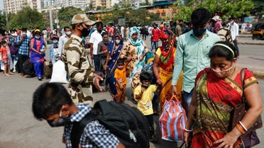 People wearing protective masks walk in a line at a railway station amidst the spread of the coronavirus disease (COVID-19) in Mumbai, India, 9 April, 2021. (Reuters)