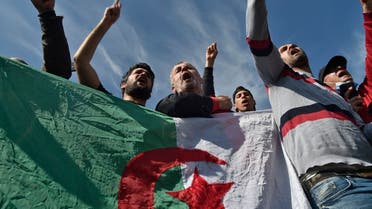 Algerians carrying a national flag gather outside the Kolea prison near the city of Tipasa, some 70km west of the capital Algiers on February 19, 2021. (Ryad Kramdi/AFP)
