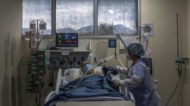 A health worker cares for a COVID-19 patient at an Intensive Care Unit (ICU) of the Ronaldo Gazolla Public Municipal Hospital in Rio de Janeiro, Brazil, on March 5, 2021. (AFP)