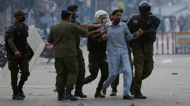 Police officers take into custody a supporter of Tehreek-e-Labiak Pakistan, a radical Islamist political party, at a protest against the arrest of their leader Saad Rizvi, in Lahore, Pakistan, Monday, April 12, 2021. (AP)