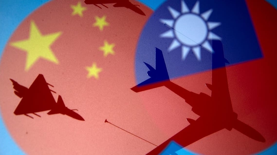 Chinese and Taiwanese national flags are displayed alongside military airplanes in this illustration taken on April 9, 2021. (Reuters)