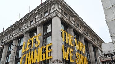 A sign reading Let's change the way we shop is pictured outside the Selfridges department store on Oxford Street in central London as coronavirus restrictions are eased after England's third national lockdown on April 12, 2021. (File photo: AFP)