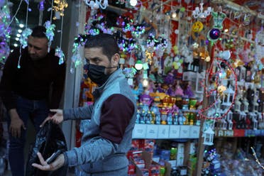 A Palestinian man gestures outside a shop displaying Ramadan decorations, ahead of the holy fasting month of Ramadan, in Gaza City . (Reuters)