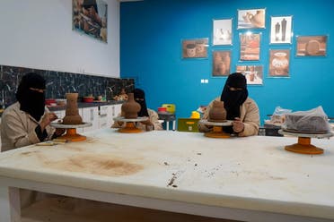 Saudi women work on pots in a workshop in AlUla, Saudi Arabia, April 8, 2021. Picture taken April 8, 2021. (Reuters)