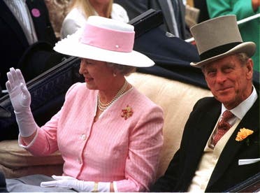 Queen Elizabeth II waves and Prince Philip smiles as their carriage is driven through the royal enclosure at the Royal Ascot racetrack June 17, 1997. Hundreds attended the first day of the annual event to see the fashions, royalty and the racing. BRITAIN