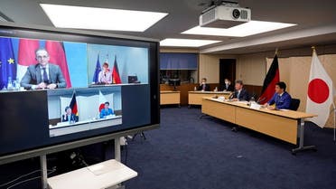 Japan's Foreign Minister Toshimitsu Motegi (2-R) and Defence Minister Nobuo Kishi (R) attend a video conference with German Foreign Minister Heiko Maas (top L, on screen) and Defence Minister Annegret Kramp-Karrenbauer (top R, on screen) at the Foreign Ministry in Tokyo, Japan, April 13, 2021. Both parties held their Foreign and Defense Ministerial Meeting '2+2' to strengthen their cooperation. (Reuters)