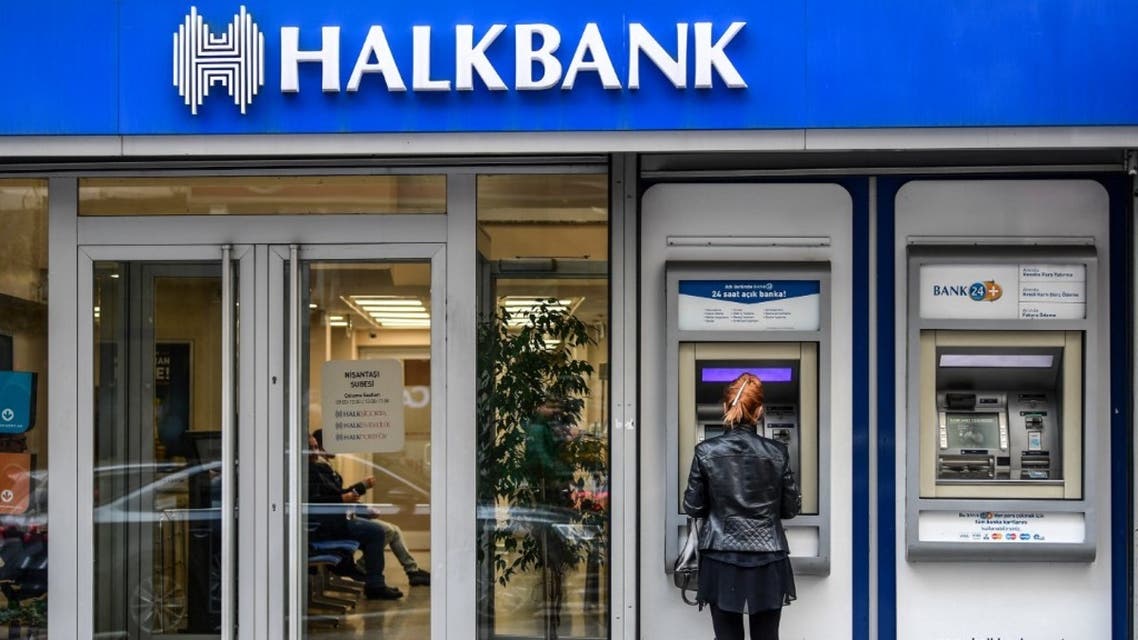 A woman uses an ATM machine at a branch of Turkish bank Halkbank on December 1, 2017 in Istanbul. (AFP)